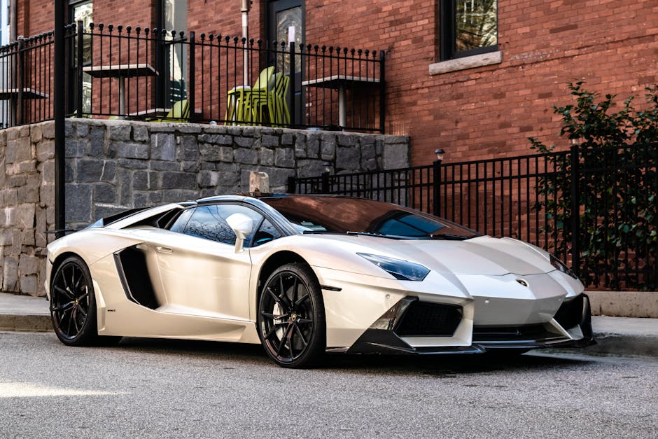 Elegant white sports car parked on a city street in Atlanta, showcasing luxury design