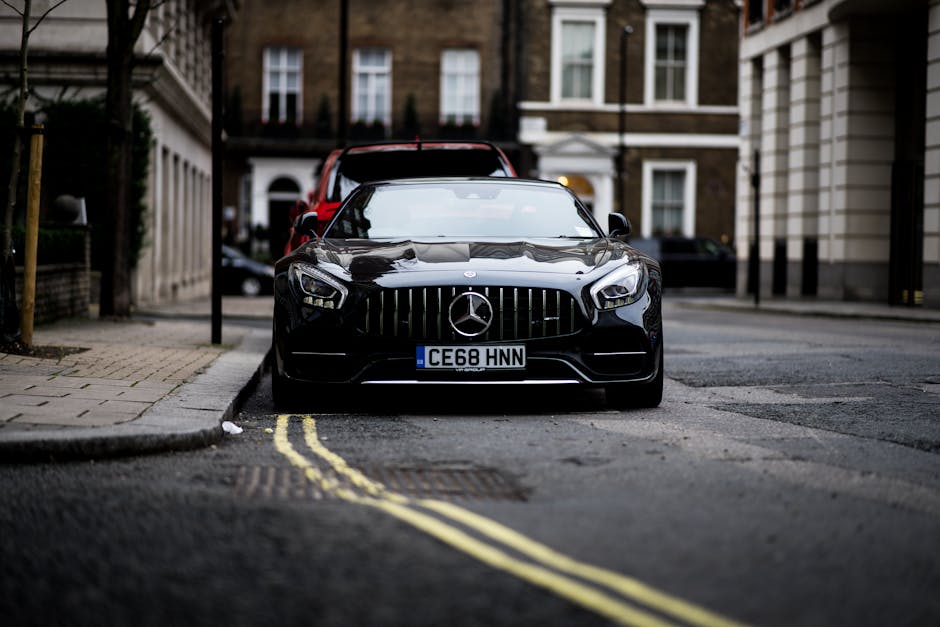 A sleek black Mercedes Benz parked on a London street, showcasing luxury and style.