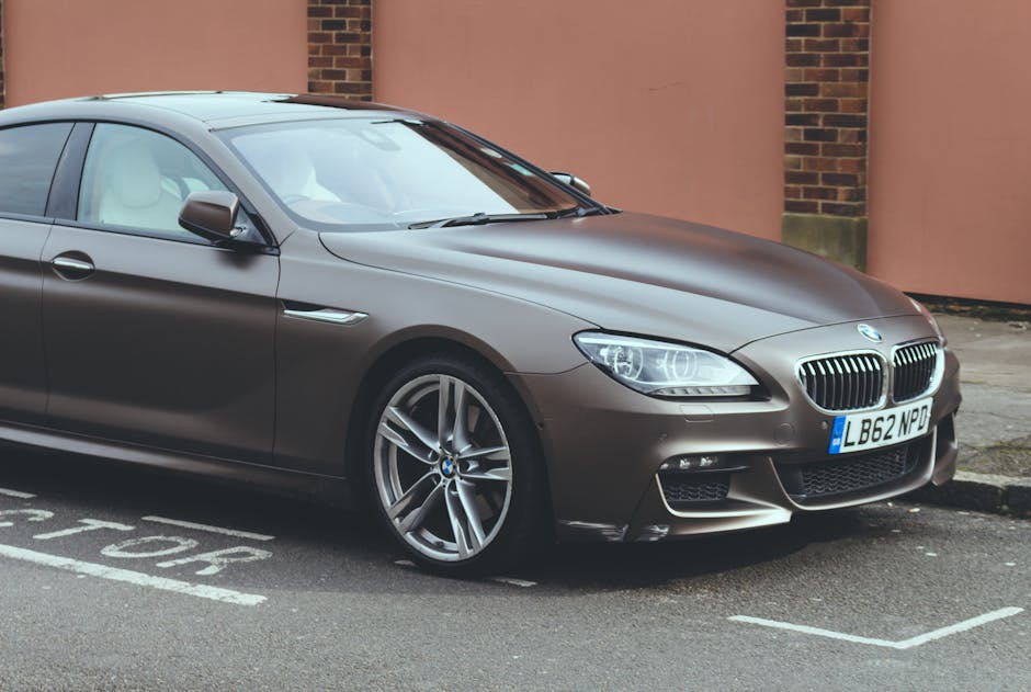 Luxury BMW 6 Series coupe parked on an urban street, showcasing sleek design and elegance.