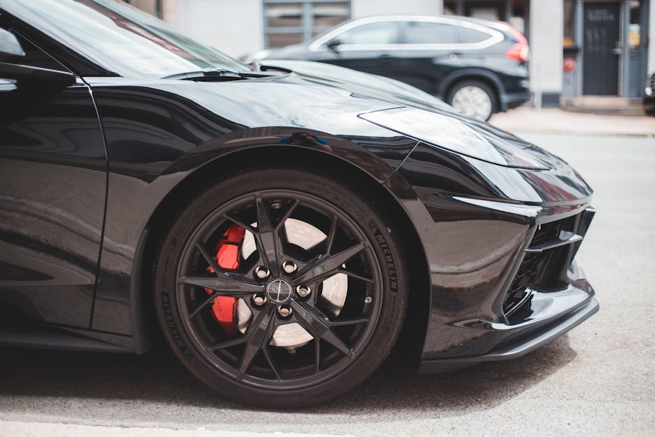 Luxury car with black wheels with metal brake discs and glossy headlight on roadside